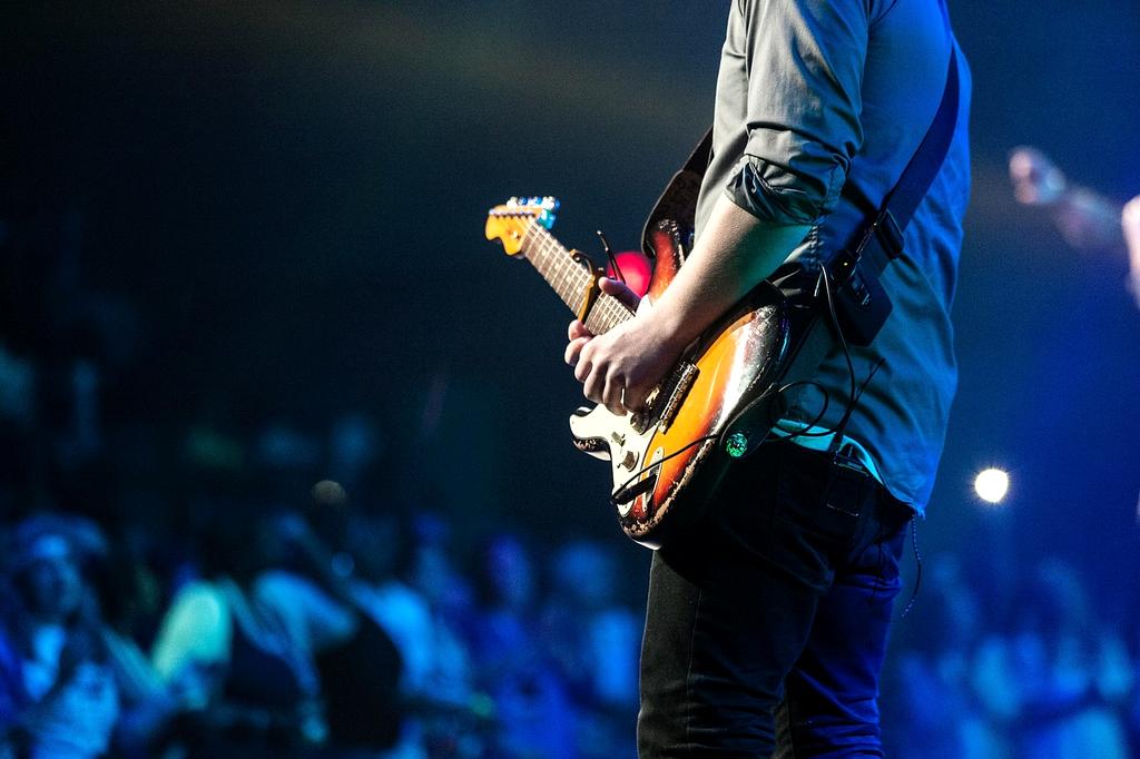 Live band performing on a small stage under stage lights